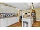 Spacious kitchen with white cabinets, countertop seating, and open to living space at 105 Whimbrel Ln, Mooresville, NC 28117