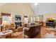 Open living room featuring a fireplace, high ceilings, and hardwood floors at 105 Whimbrel Ln, Mooresville, NC 28117