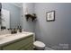 Small bathroom with green vanity and a white countertop at 123 Kingfisher Dr, Mooresville, NC 28117