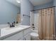 Clean bathroom with tub shower, vanity, and neutral decor at 123 Kingfisher Dr, Mooresville, NC 28117