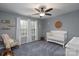 Bedroom with crib, rocking chair, and plenty of natural light at 123 Kingfisher Dr, Mooresville, NC 28117