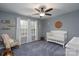 Charming bedroom with gray walls, a crib, and a rocking chair at 123 Kingfisher Dr, Mooresville, NC 28117