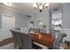 Open concept dining room with a large table, gray chairs, and a view into the kitchen at 123 Kingfisher Dr, Mooresville, NC 28117