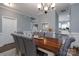 Open dining room with a farmhouse table and view into the kitchen at 123 Kingfisher Dr, Mooresville, NC 28117