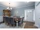 Formal dining room with a wood table, gray chairs, and entryway view at 123 Kingfisher Dr, Mooresville, NC 28117