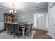 Bright dining room with a farmhouse table, gray chairs, and a view of the entryway at 123 Kingfisher Dr, Mooresville, NC 28117