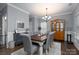 Formal dining room featuring a rustic table, gray chairs, and a wooden hutch at 123 Kingfisher Dr, Mooresville, NC 28117