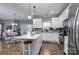 Open concept kitchen with white cabinets, island, and dining area at 123 Kingfisher Dr, Mooresville, NC 28117