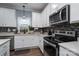 Clean kitchen with white cabinets and stainless steel range and microwave at 123 Kingfisher Dr, Mooresville, NC 28117