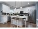 Modern kitchen with white cabinets, an island, and stainless steel appliances at 123 Kingfisher Dr, Mooresville, NC 28117