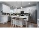 Modern kitchen with white cabinets, stainless steel appliances, and an island at 123 Kingfisher Dr, Mooresville, NC 28117