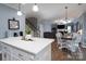 Open kitchen features white cabinets, quartz countertops, and a view into the dining area at 123 Kingfisher Dr, Mooresville, NC 28117