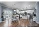 Eat-in kitchen with white cabinets, island, and hardwood floors at 123 Kingfisher Dr, Mooresville, NC 28117