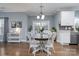 Bright kitchen with white cabinets, round dining table, and sliding glass doors to the deck at 123 Kingfisher Dr, Mooresville, NC 28117