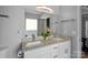 Double vanity bathroom with granite countertops and large mirror at 13917 Sugar Oats Ln, Charlotte, NC 28213