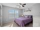 Spacious bedroom with purple bedding and large window at 13917 Sugar Oats Ln, Charlotte, NC 28213