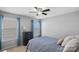 Bedroom with blue bedding, double windows and dresser at 13917 Sugar Oats Ln, Charlotte, NC 28213