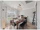 Bright dining room featuring a wood table, bench seating, and large windows at 13917 Sugar Oats Ln, Charlotte, NC 28213