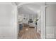 Elegant entryway with arched doorway, hardwood floors, and white columns at 13917 Sugar Oats Ln, Charlotte, NC 28213