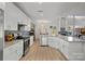 Open kitchen with white cabinets and granite countertops at 13917 Sugar Oats Ln, Charlotte, NC 28213