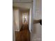 Long hallway with hardwood floors and doors to bedrooms at 1426 Reid Harkey Rd, Matthews, NC 28105