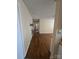 Long hallway with hardwood floors and neutral walls at 1426 Reid Harkey Rd, Matthews, NC 28105