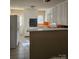 Galley kitchen with white cabinets and orange countertops at 1426 Reid Harkey Rd, Matthews, NC 28105