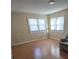 Living room with hardwood floors and multiple windows at 1426 Reid Harkey Rd, Matthews, NC 28105