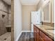 Bathroom with granite countertop, wood cabinets, and tiled shower at 1744 White Fawn Ln, Rock Hill, SC 29730