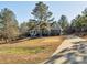 House exterior showcasing landscaping and a paved driveway leading to the home at 1744 White Fawn Ln, Rock Hill, SC 29730