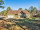 View of house exterior showcasing green siding and a double garage at 1744 White Fawn Ln, Rock Hill, SC 29730