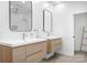 Modern bathroom with double sinks, wood cabinets, and herringbone tile at 19216 Wildcat Trl, Davidson, NC 28036