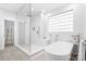 Spa-like bathroom with soaking tub, walk-in shower, and modern fixtures at 19216 Wildcat Trl, Davidson, NC 28036