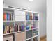 Organized bookshelves with various books and storage at 19216 Wildcat Trl, Davidson, NC 28036