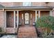 Brick front porch with arched entryway and tile flooring at 19216 Wildcat Trl, Davidson, NC 28036