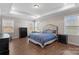 Main bedroom with plush bed, hardwood floors and plenty of light at 298 Bouchard Dr, Waxhaw, NC 28173