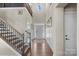 Two-story foyer with hardwood floors, staircase, and wainscoting at 298 Bouchard Dr, Waxhaw, NC 28173