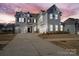 Two-story house with gray siding, three-car garage, and a basketball goal at 298 Bouchard Dr, Waxhaw, NC 28173