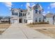 Two-story house with gray siding, three-car garage, and a basketball goal at 298 Bouchard Dr, Waxhaw, NC 28173