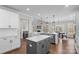 Large kitchen with two islands, white cabinets and hardwood floors at 298 Bouchard Dr, Waxhaw, NC 28173