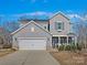 Two-story gray house with white garage door and landscaping at 3001 Cedric Ct, Fort Mill, SC 29715