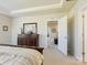 Main bedroom with dresser, ensuite bathroom access, and carpeted floors at 3001 Cedric Ct, Fort Mill, SC 29715