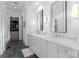 Elegant bathroom with dual sinks, marble countertop, stylish mirrors, and chic herringbone tile floor at 336 Anthony Cir, Charlotte, NC 28211