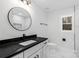 Stylish bathroom with black finishes, marble tile, and a round mirror at 375 Woodwedge Cir, Salisbury, NC 28144