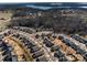 Aerial view showcasing a lake and houses at 517 Trillium Way, Belmont, NC 28012