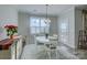 Bright dining area with white table and chairs, and access to patio at 517 Trillium Way, Belmont, NC 28012