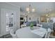 Bright dining room with white table, chairs, and view into living room at 517 Trillium Way, Belmont, NC 28012