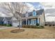 Charming house with gray siding, stone accents, and a landscaped yard at 517 Trillium Way, Belmont, NC 28012