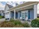 Relaxing front porch with white chairs and potted plants at 517 Trillium Way, Belmont, NC 28012