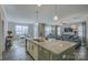 Open kitchen with island, stainless steel appliances, and breakfast area at 517 Trillium Way, Belmont, NC 28012